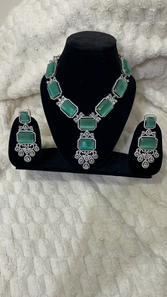 Emerald green american diamond necklace set with silver toned accent